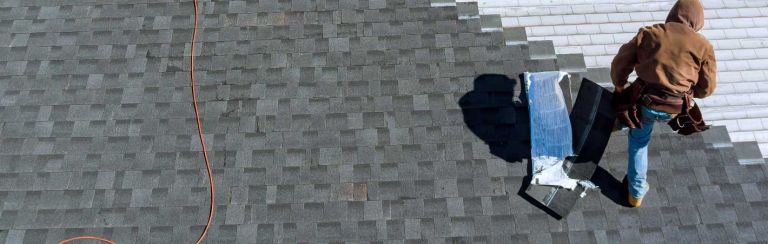Roofer working on roof 768x244